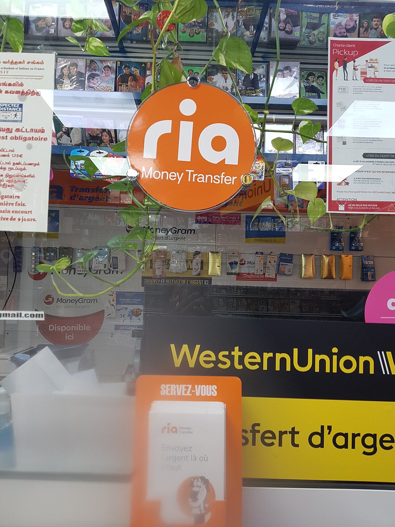 한 가게에 Ria와 Western Union 간판이 함께 걸려 있는 모습