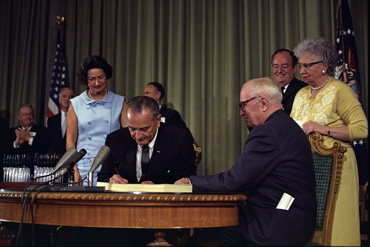LBJ signing the Medicare bill with Harry Truman, July 30 1965
